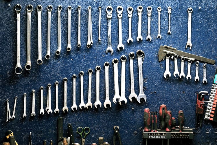 Assorted tools and wrenches hung on a wall
