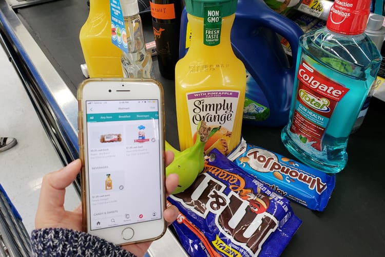 A person using the Ibotta app while checking out at Walmart