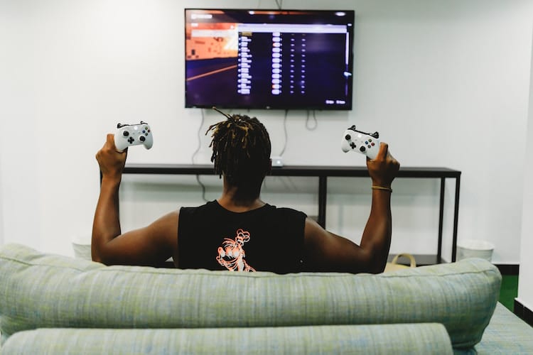 A man playing xbox on his couch