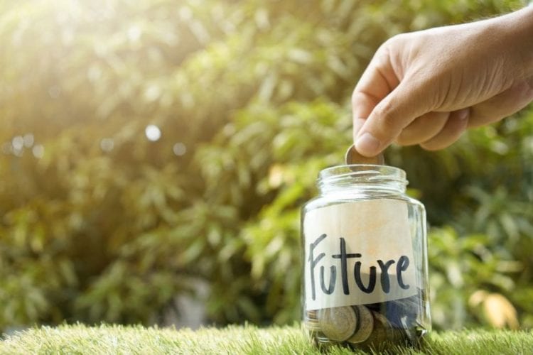 A person dropping coins into a jar labeled "future"
