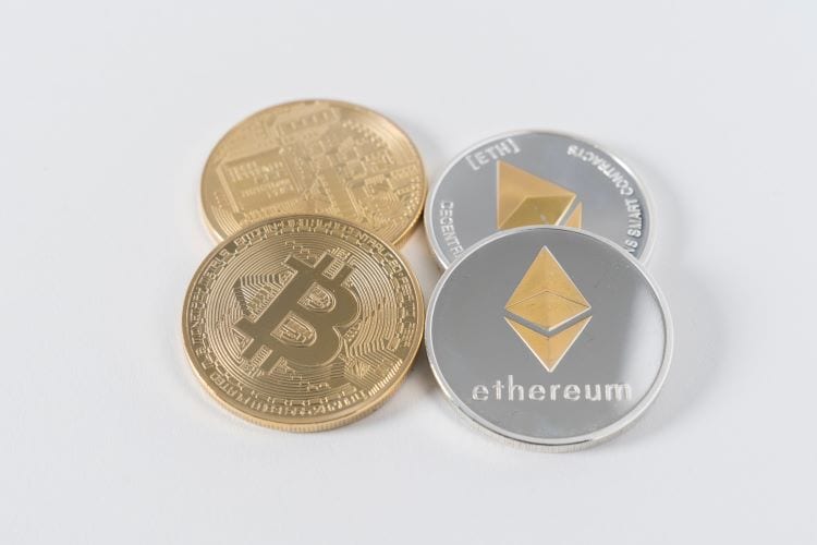 Physical Bitcoins and Ethereum coins side by side