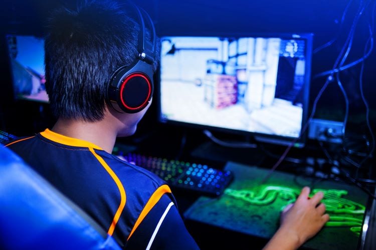 A shot from behind of a competitive gamer at a match