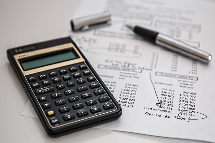 A pen, a calculator, and a financial document