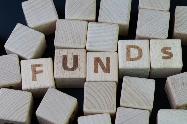 Wood blocks with letters spelling the word "funds"
