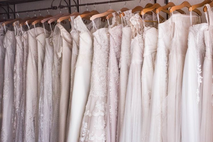 A row of wedding dresses on hangers