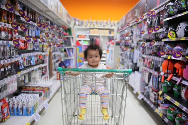 A baby in a shopping cart 