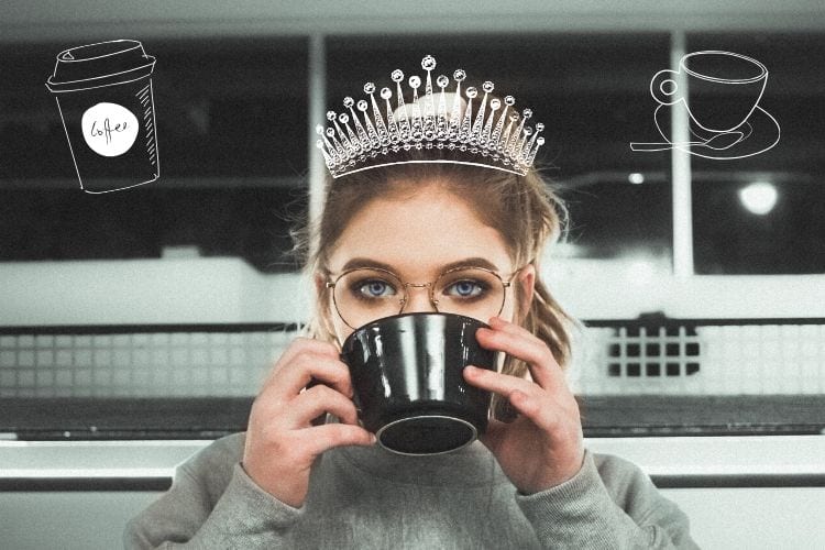 A woman with a drawn-on crown drinking coffee from a mug
