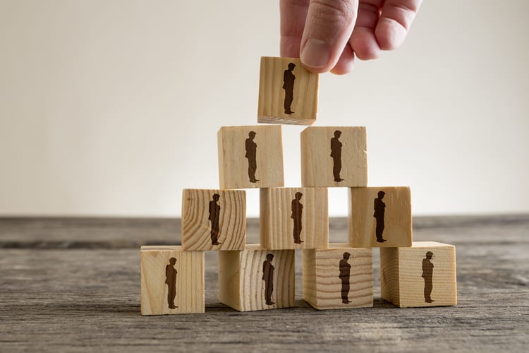 A stack of small wood blocks will an illustration of a person on each