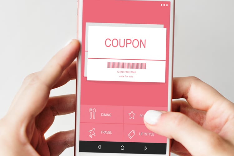 A phone showing a digital coupon and barcode 