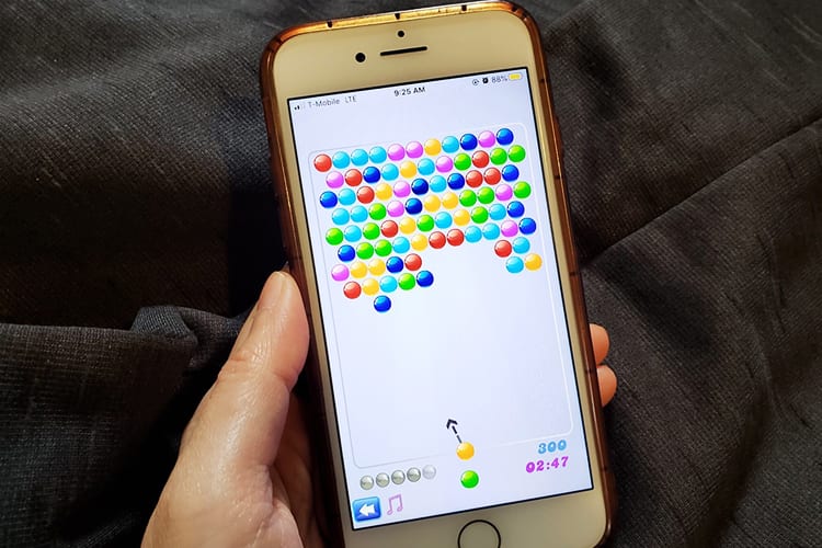An iPhone using the Bubble Shooter! Tournaments app