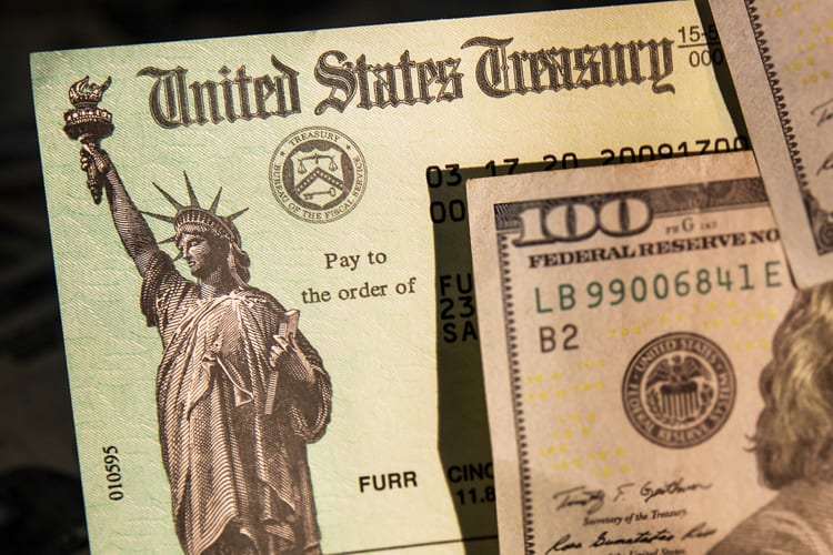 A $100 bill on top of a U.S. tax return