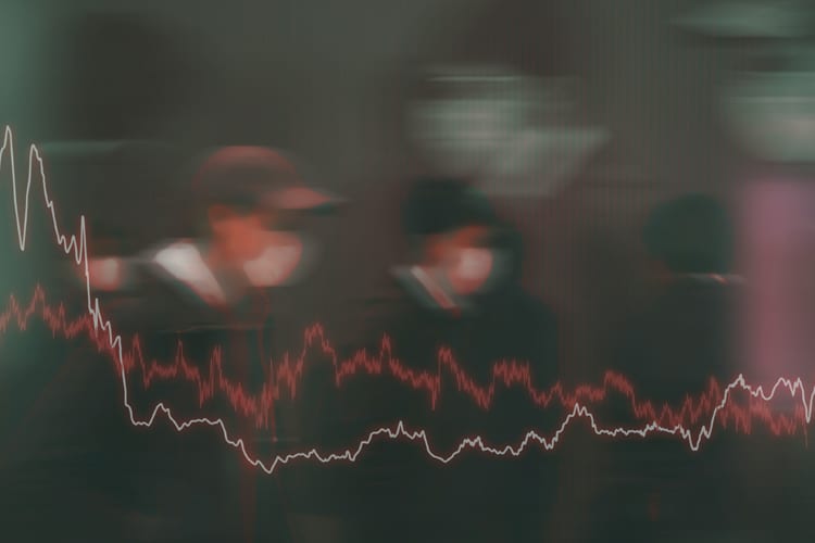 Two downward trending stock lines overlayed on an image of people wearing masks 