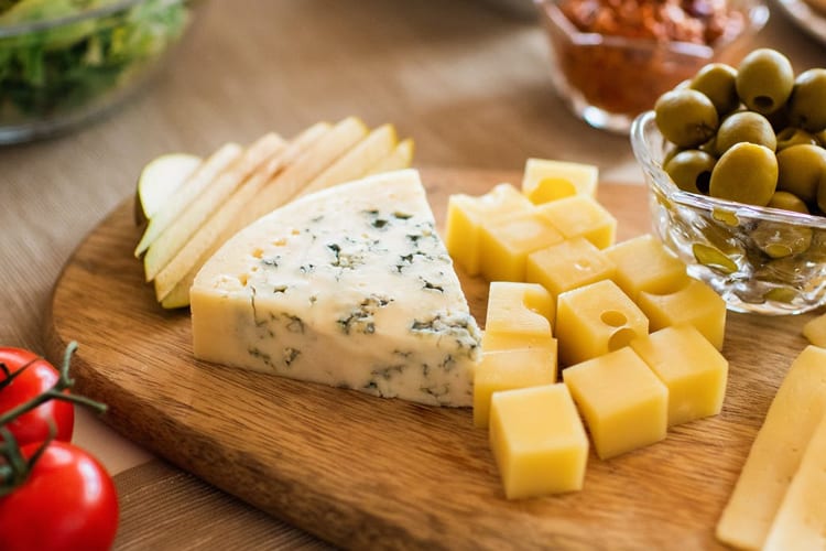 A cheese spread on a wooden board