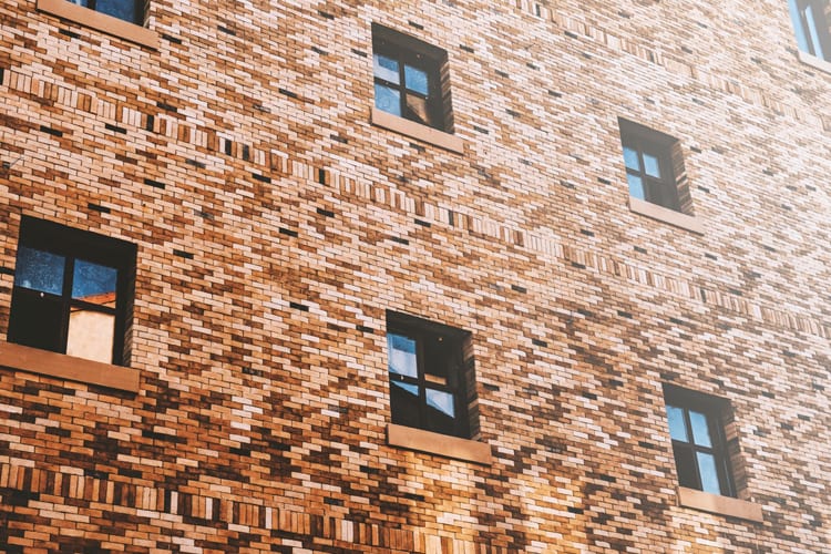Brick wall with square 4-pane windows