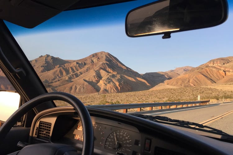 A view of mountains through a car windsheild