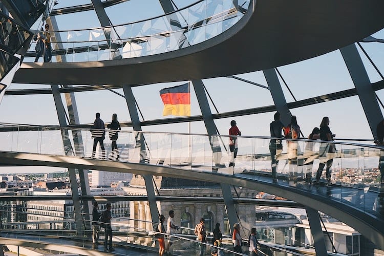 A German flag flying through the windows of the Reichstag