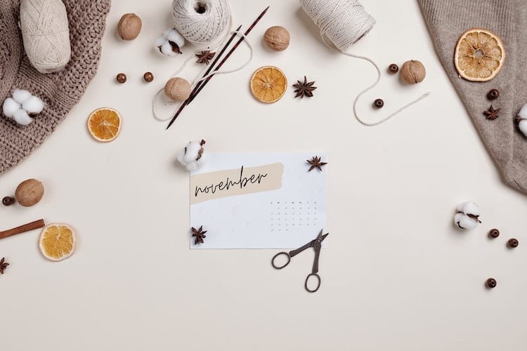 A November calendar surrounded by arts and crafts materials