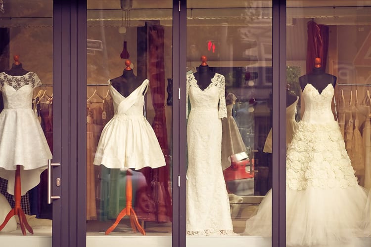 Window display of four different wedding dresses