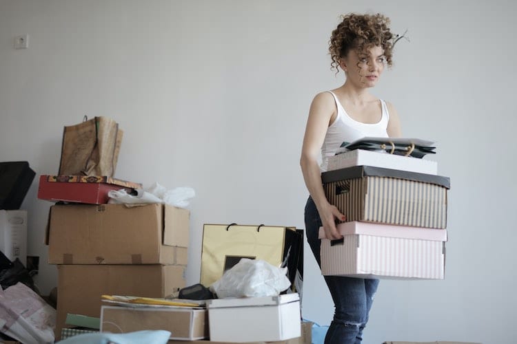 A young woman moving boxes