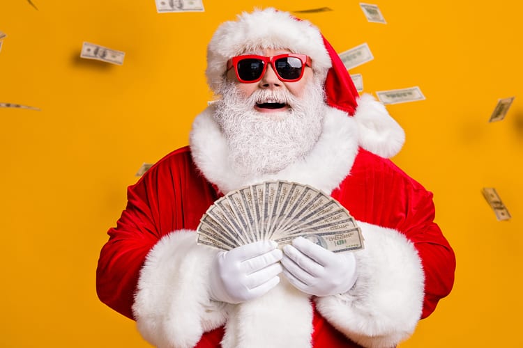 Santa with sunglasses holding cash with bills flying around